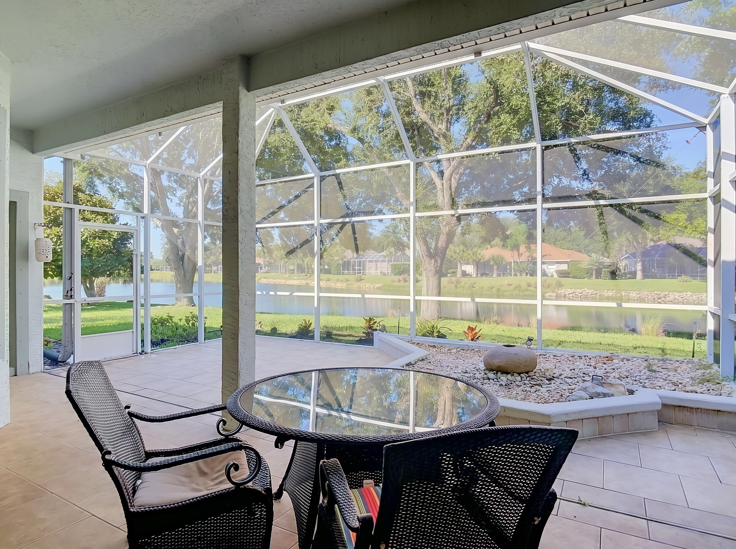 Screened lanai at 14 Egret Drive overlooking the pond