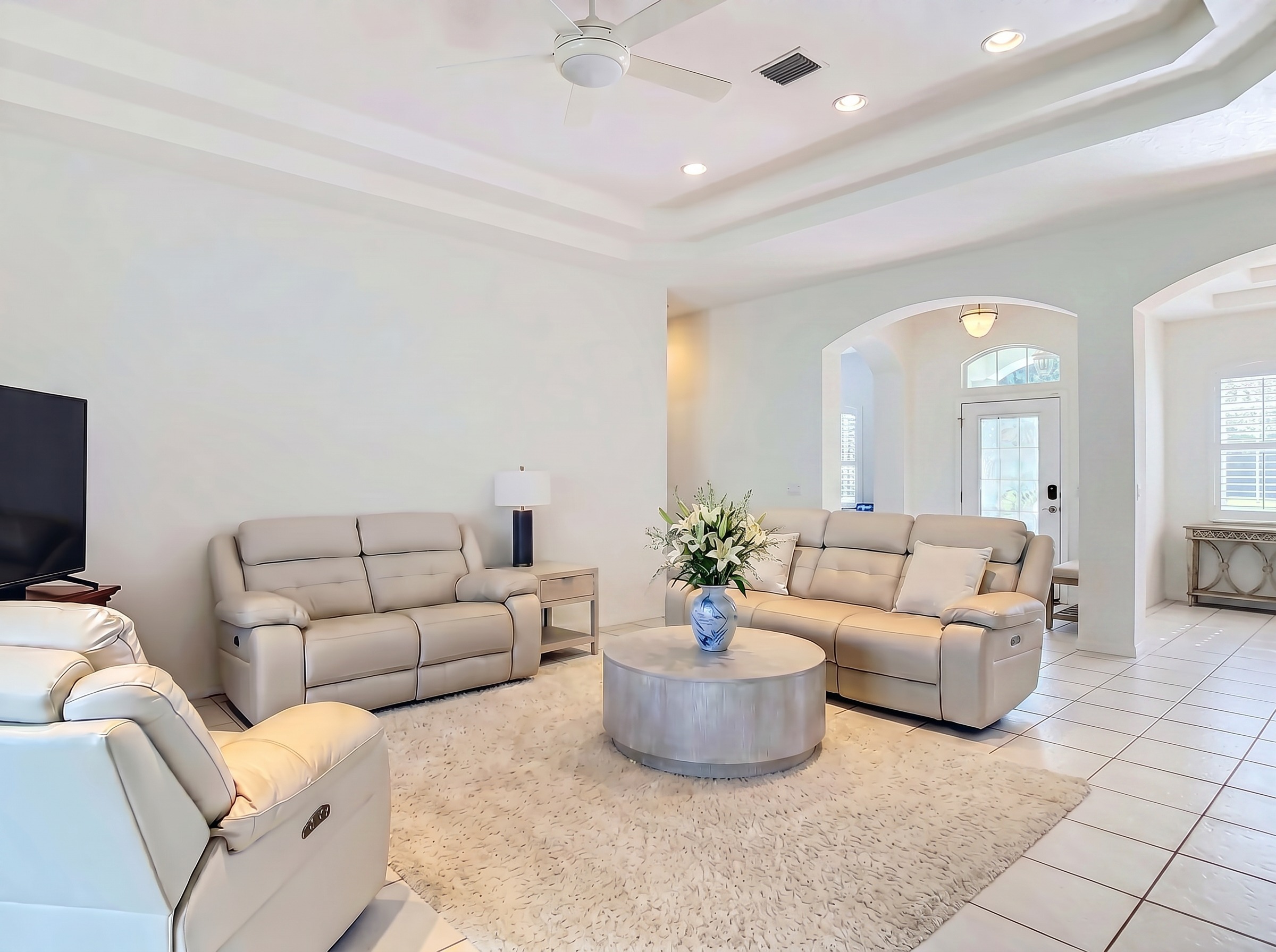 Vaulted-ceiling living room with lake sightlines at 14 Egret Drive