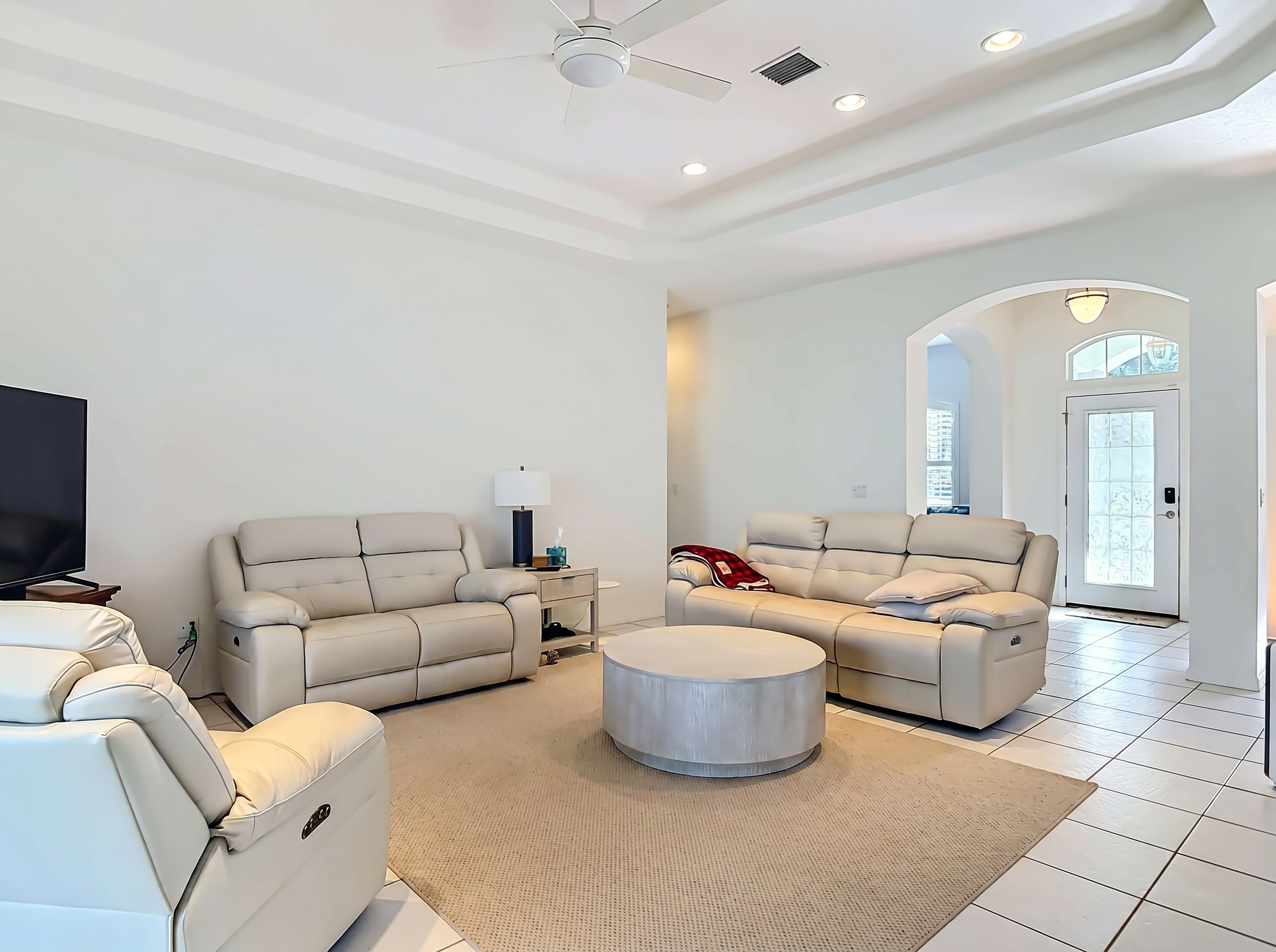 Vaulted-ceiling living room with lake sightlines at 14 Egret Drive