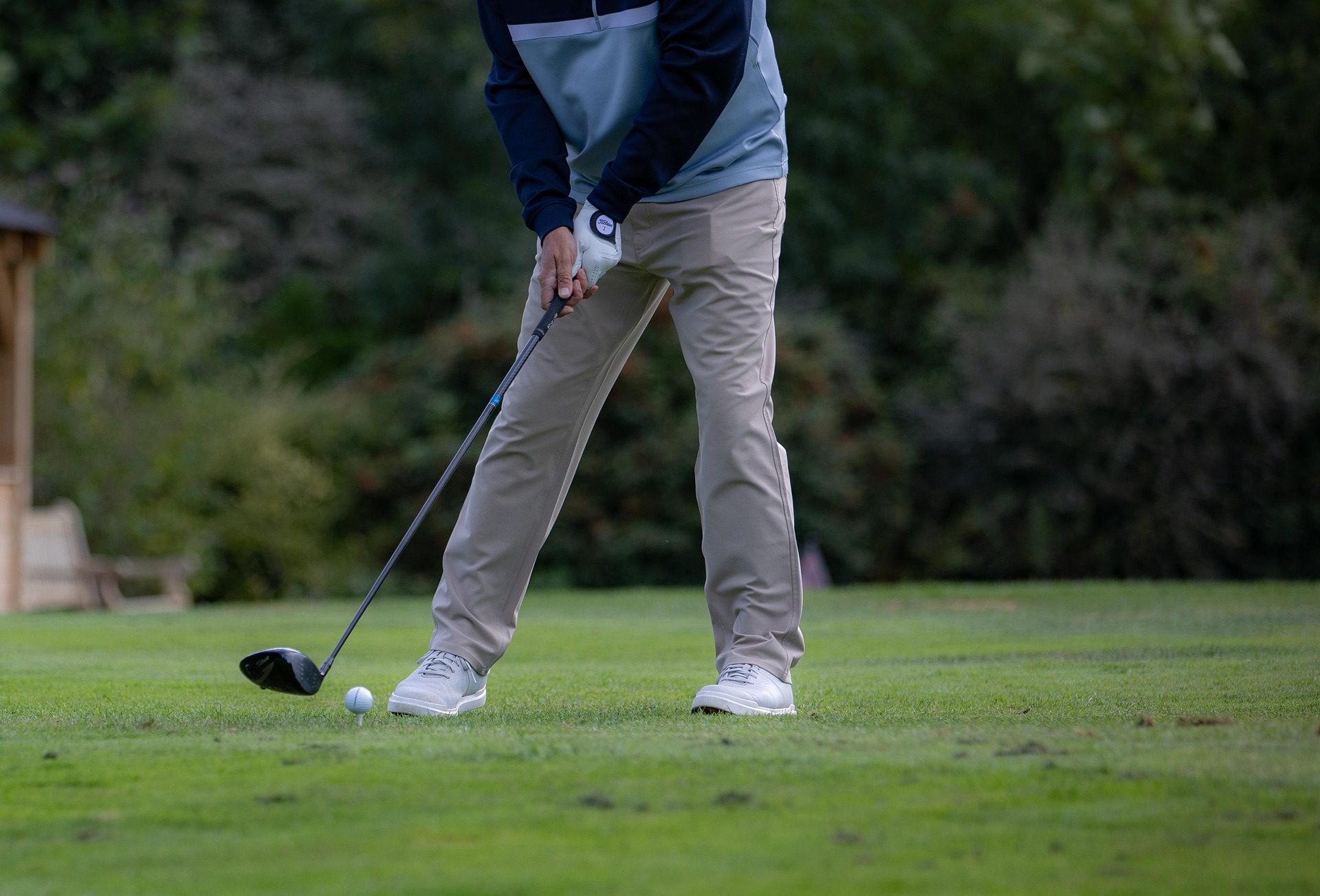 Golfers walking on a fairway near the ocean